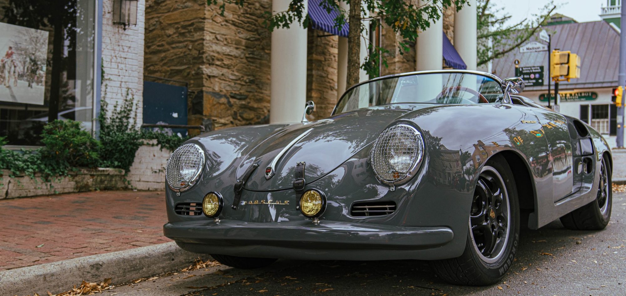 Grey Porsche Speedster parked on a brick-lined Virginia street, a classic wedding getaway car for photos